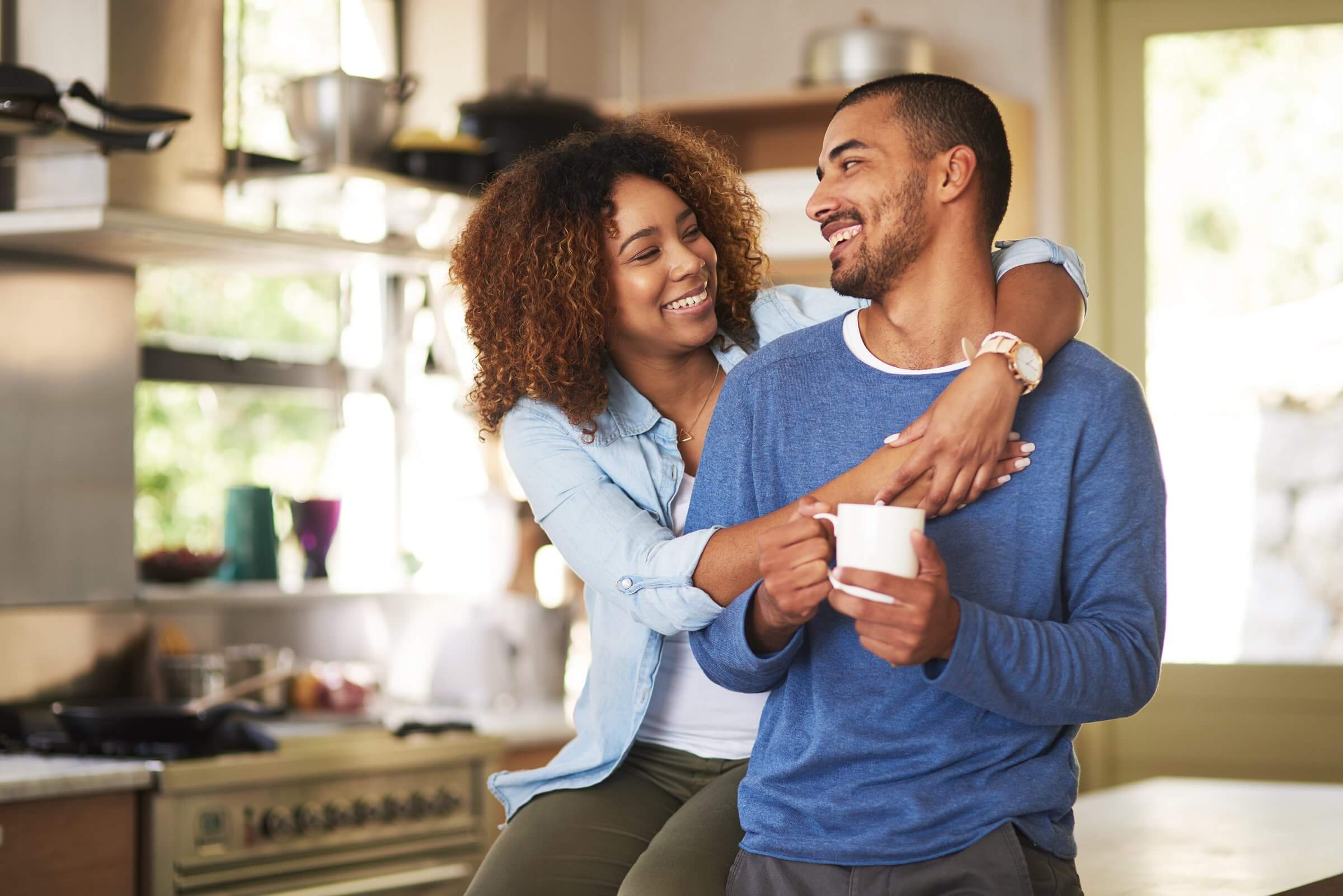 Happy couple smiling at each other after relaxing and reducing stress together.