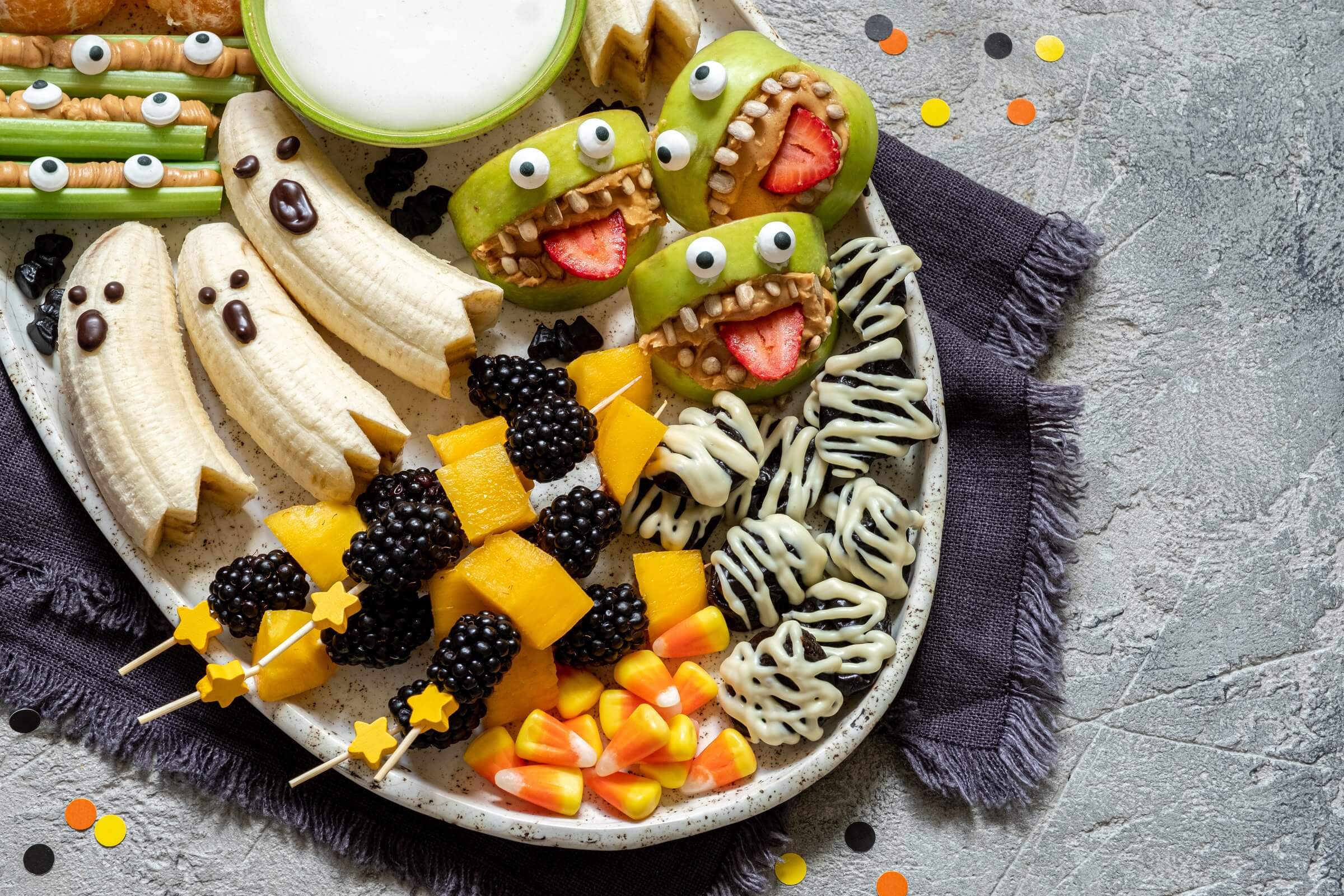 Plate filled with fun and healthy Halloween snacks.