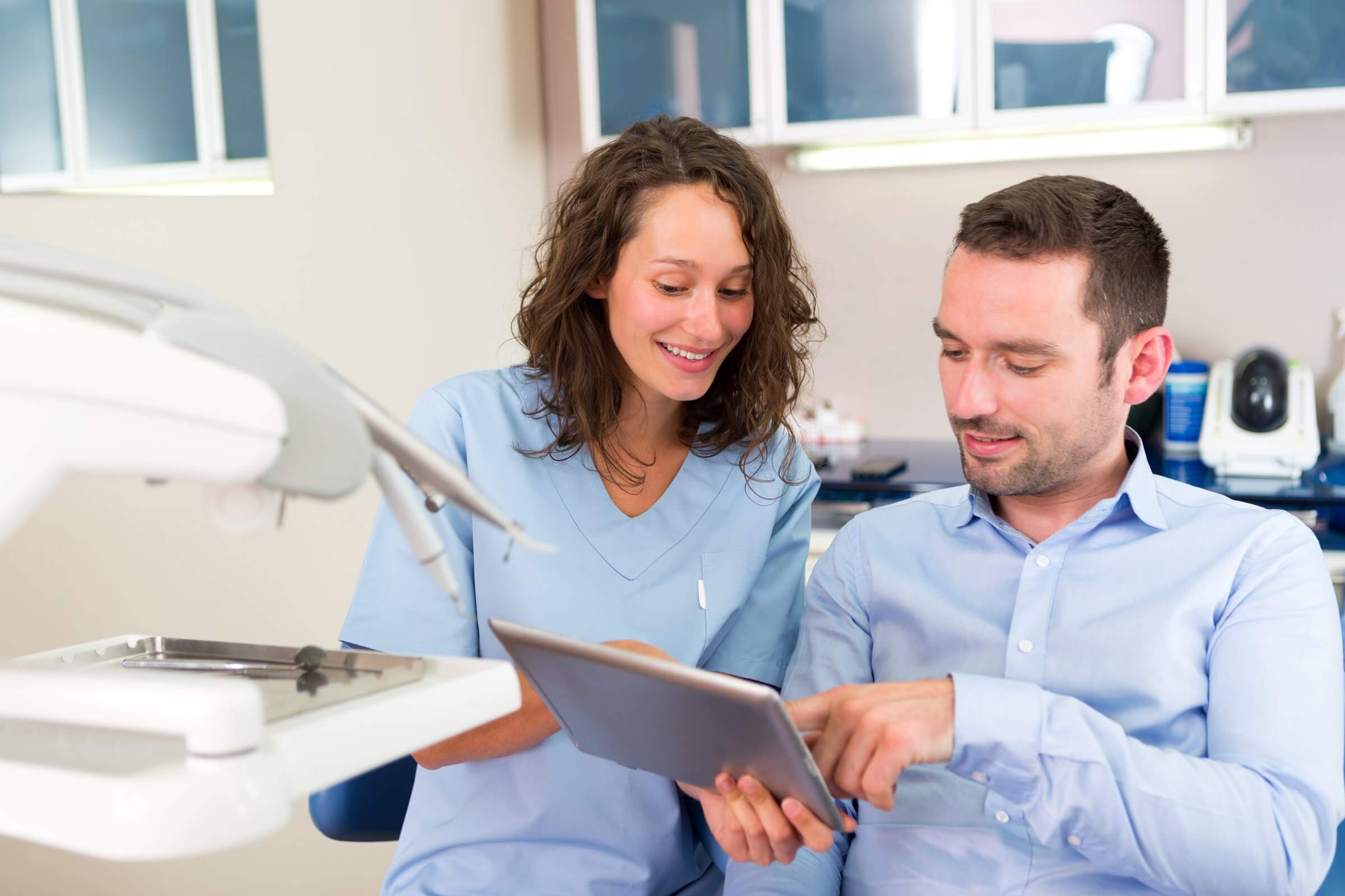 Orthodontist explaining treatment options to a new adult patient considering orthodontic care.