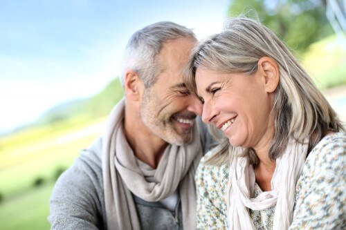 Older couple sharing a laugh and hugging