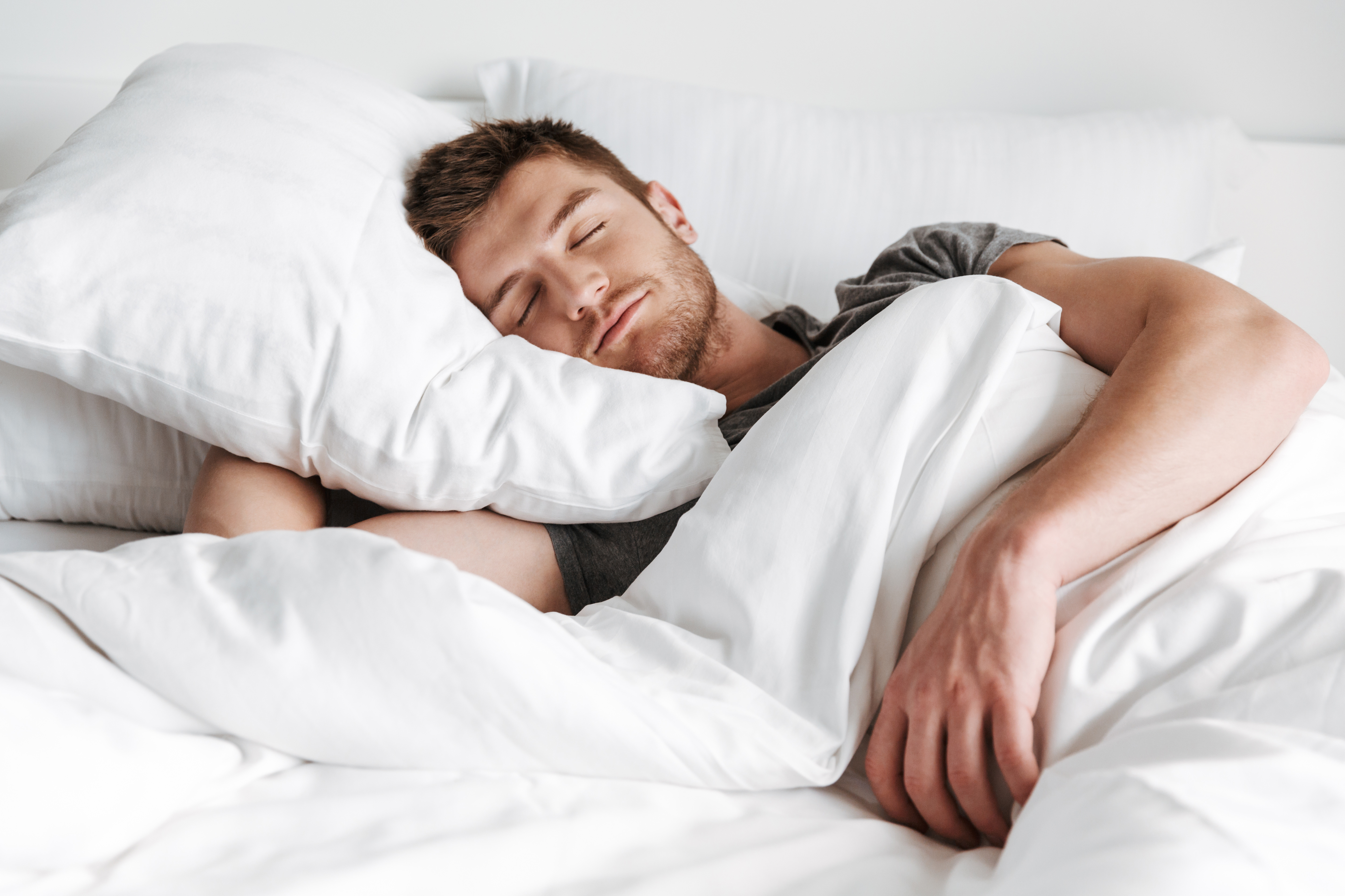 Man sleeping soundly in bed.