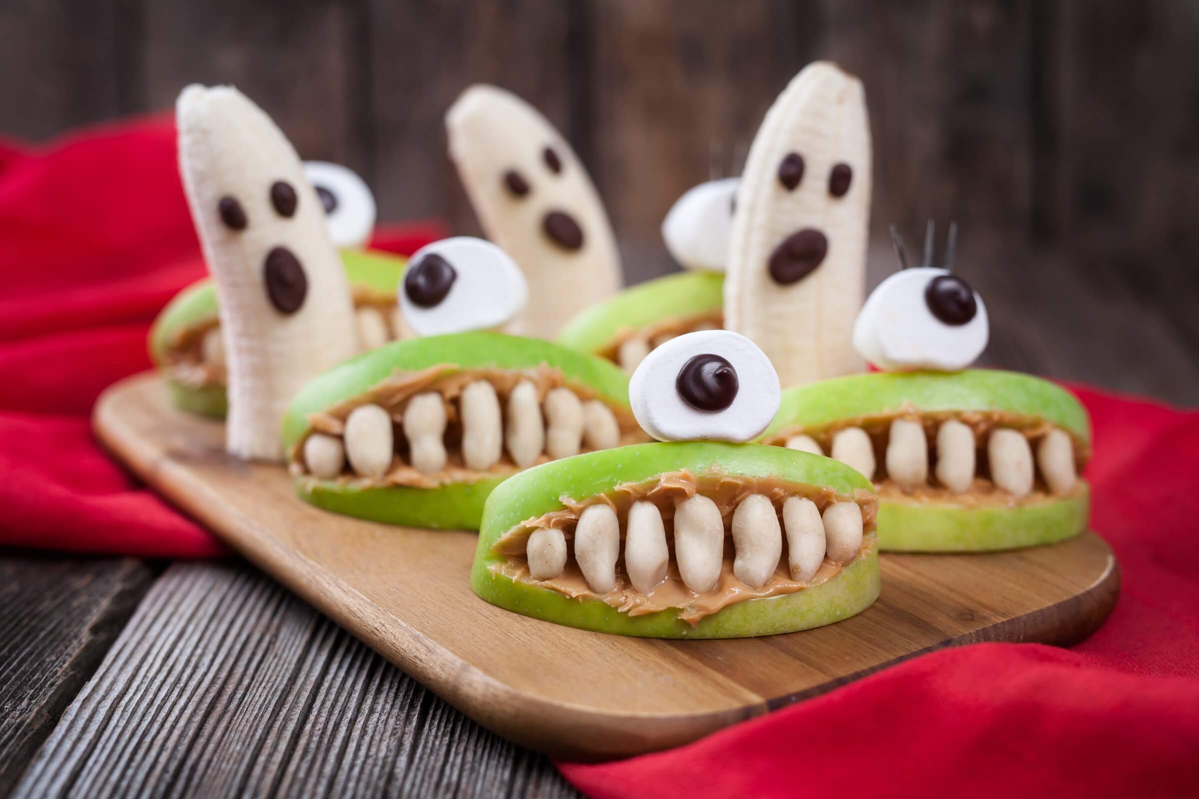 Table filled with festive, kid-friendly Halloween snacks made with healthy ingredients.
