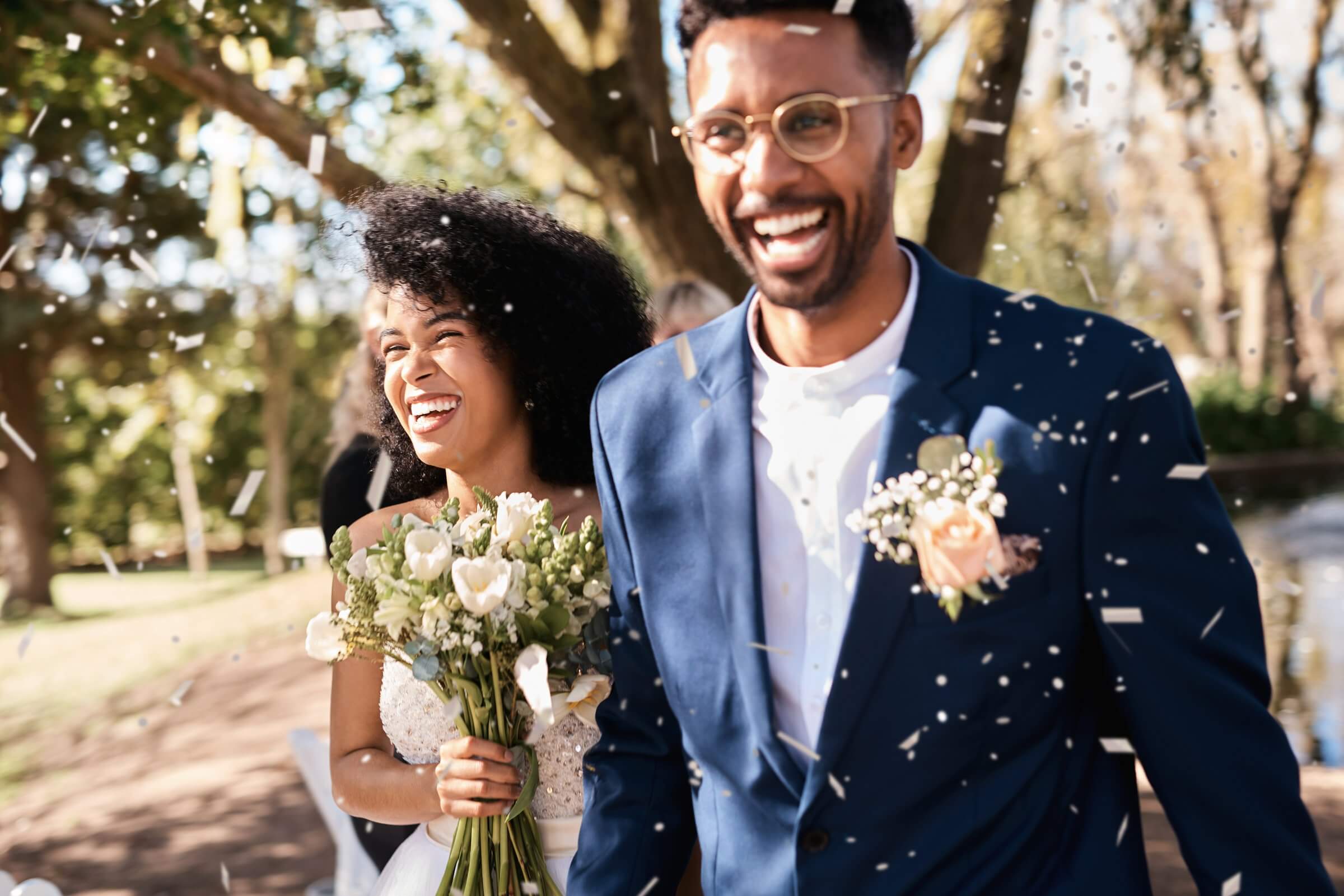 Bride and groom dance and celebrate as they walk down the aisle just after saying ‘I do.’